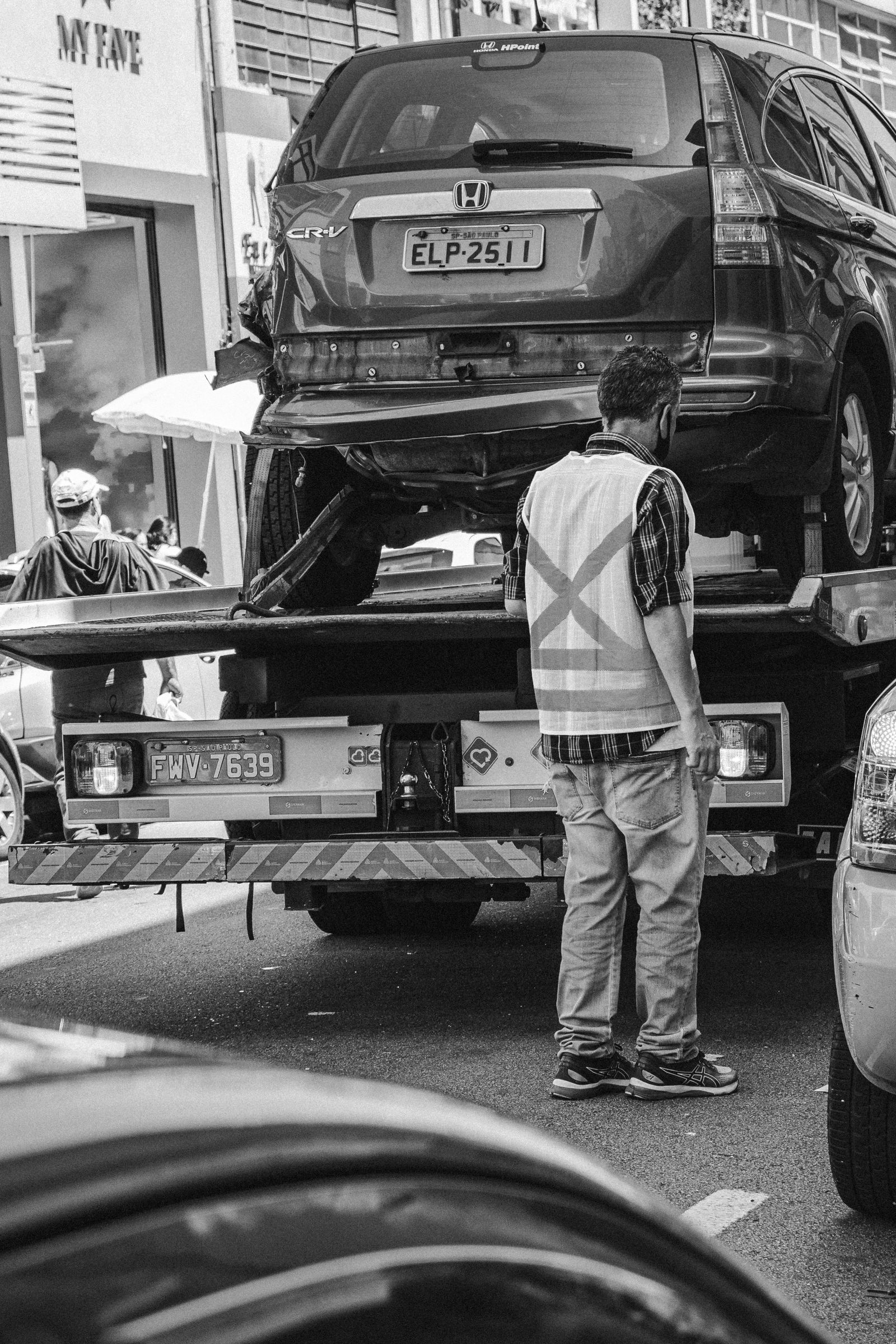 Tow truck loading a vehicle on the street